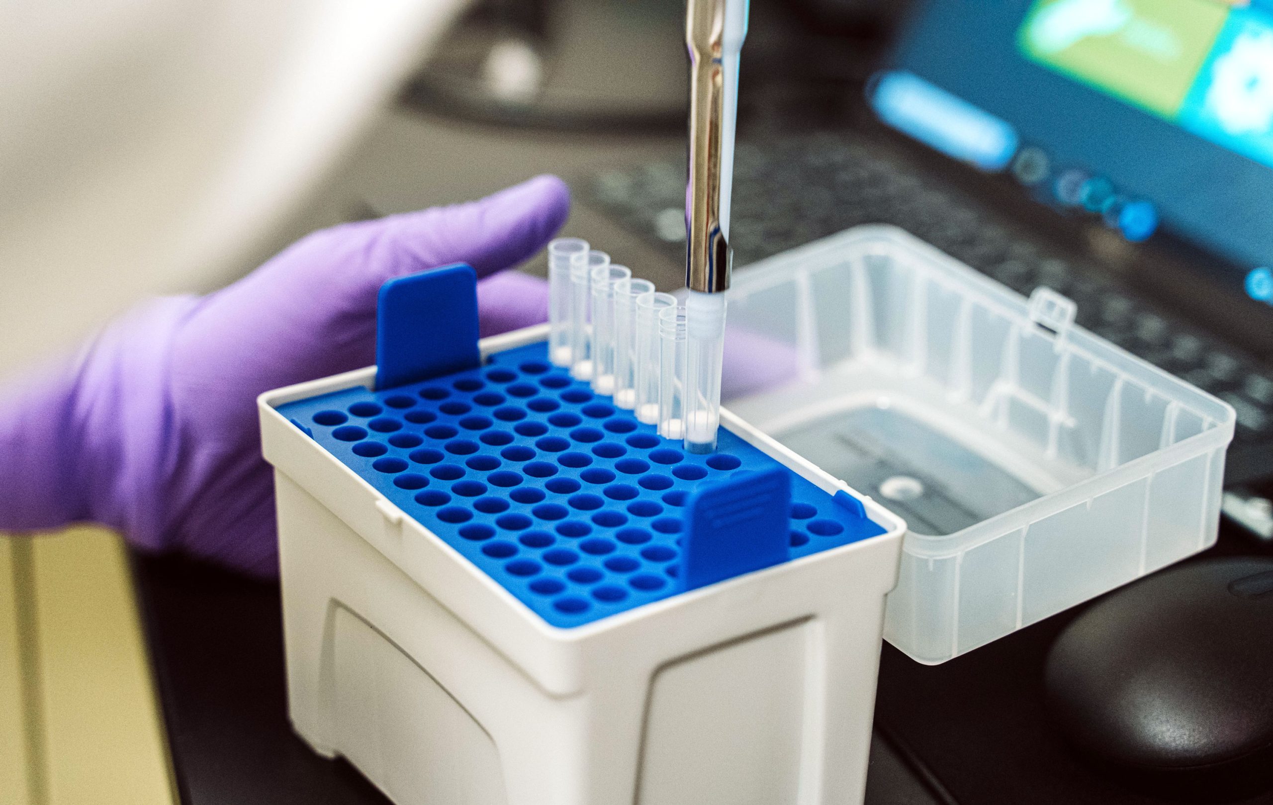 A pipette depsits samples in a rack of vials for an experiment at WiCell.