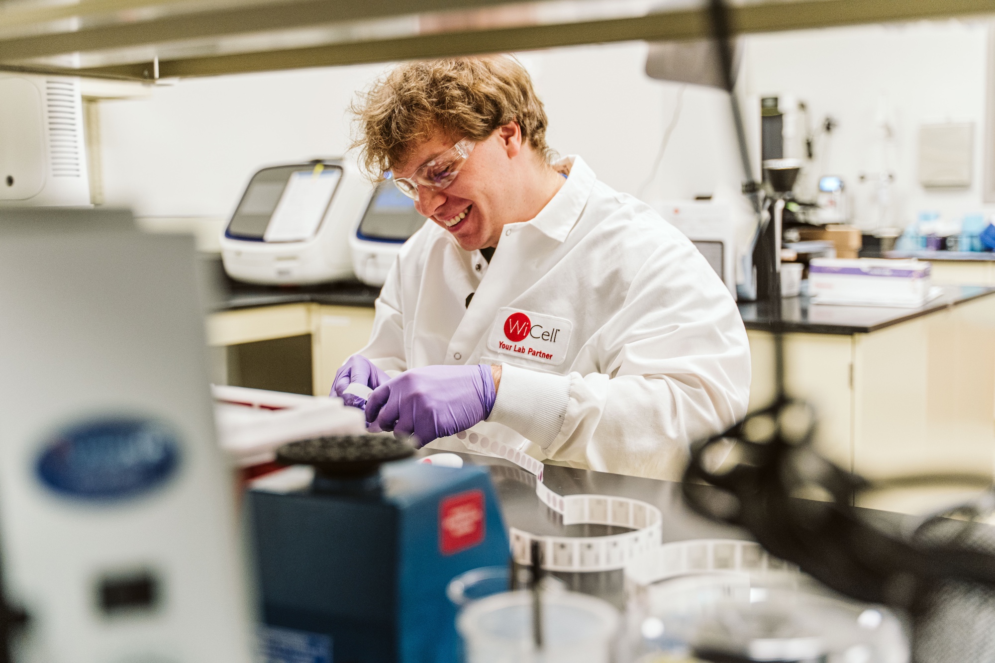 A WiCell scientist smiles as he works in the stem cell lab.