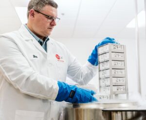 A WiCell scientist pulls out a box of stem cells from cold storage. 